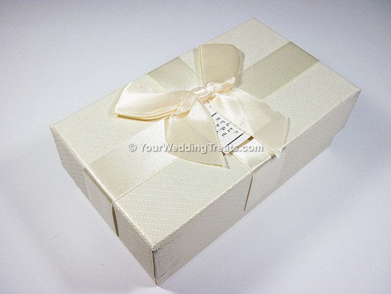white cardboard favor box with ribbon message